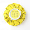 Yellow fabric pack with black lines featuring the text Fruit Hope Love