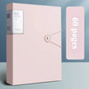 A pink A4 expanding file organizer with clear pocket dividers and a hinge closure.