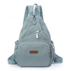 A light blue waterproof nylon crossbody sling bag worn on the back.