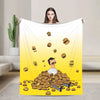A yellow cartoon illustration of a man surrounded by numerous small food items on a white blanket.