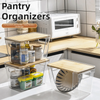 Stackable clear pantry organizers with bamboo lids holding various kitchen spices and dry goods.