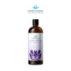 A dark brown glass bottle of Lavender Massage Oil with a light purple label and lavender flowers.