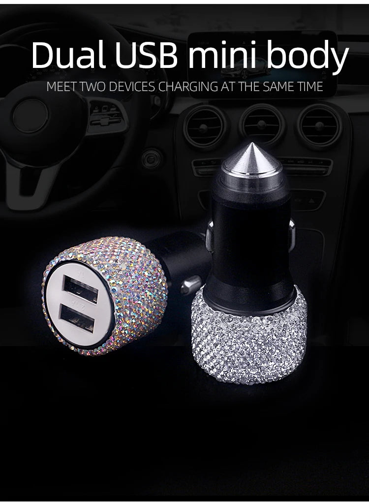 A dual USB mini body car charger with rhinestone accents is shown resting on a black car interior dashboard.