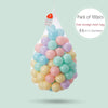 Pack of 100 soft play pit balls in various shades of blue, pink, and yellow inside a mesh bag