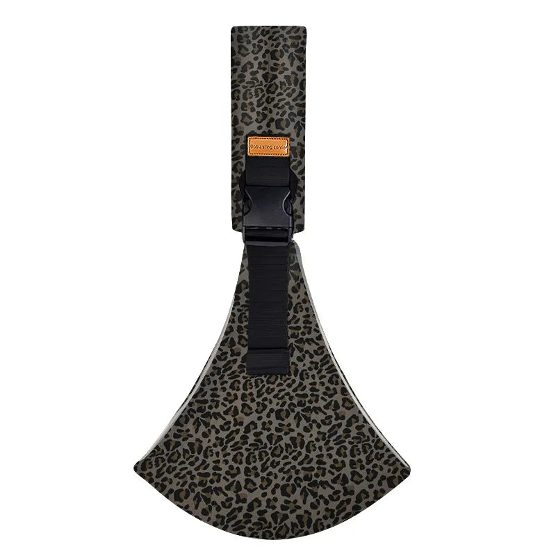 A black leopard print ergonomic baby sling carrier with a padded hip seat.