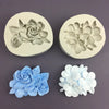 Two silicone molds showing floral designs in gray and white tones for baking and crafting