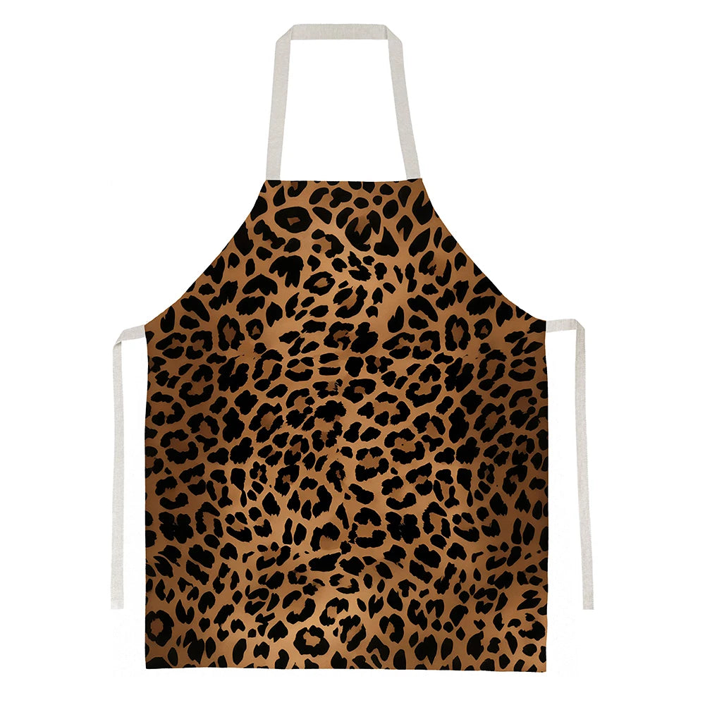 A brown and black leopard print kitchen apron with white ties.
