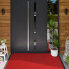 A modern dark gray double door with vertical silver accents set into a wooden wall, featuring a red doormat on the ground.