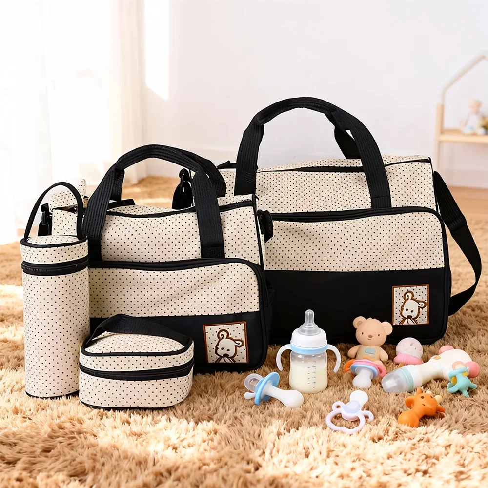 A beige and black multifunctional diaper bag set with various accessories like bottles and toys