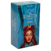 A box of the Licht und Schatten Tarot deck with a guidebook featuring a woman's face.