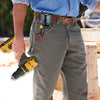 A person wearing denim shirt and jeans is holding a yellow rotating tool belt hook attached to a leather belt.