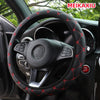 Black steering wheel with red embroidered leather stitching installed in a car interior.