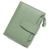 A light sage green genuine leather RFID blocking bifold wallet shown from above.