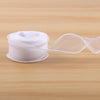 A roll of white satin ribbon, 10 yards long and 40mm wide, lying on a wooden surface.
