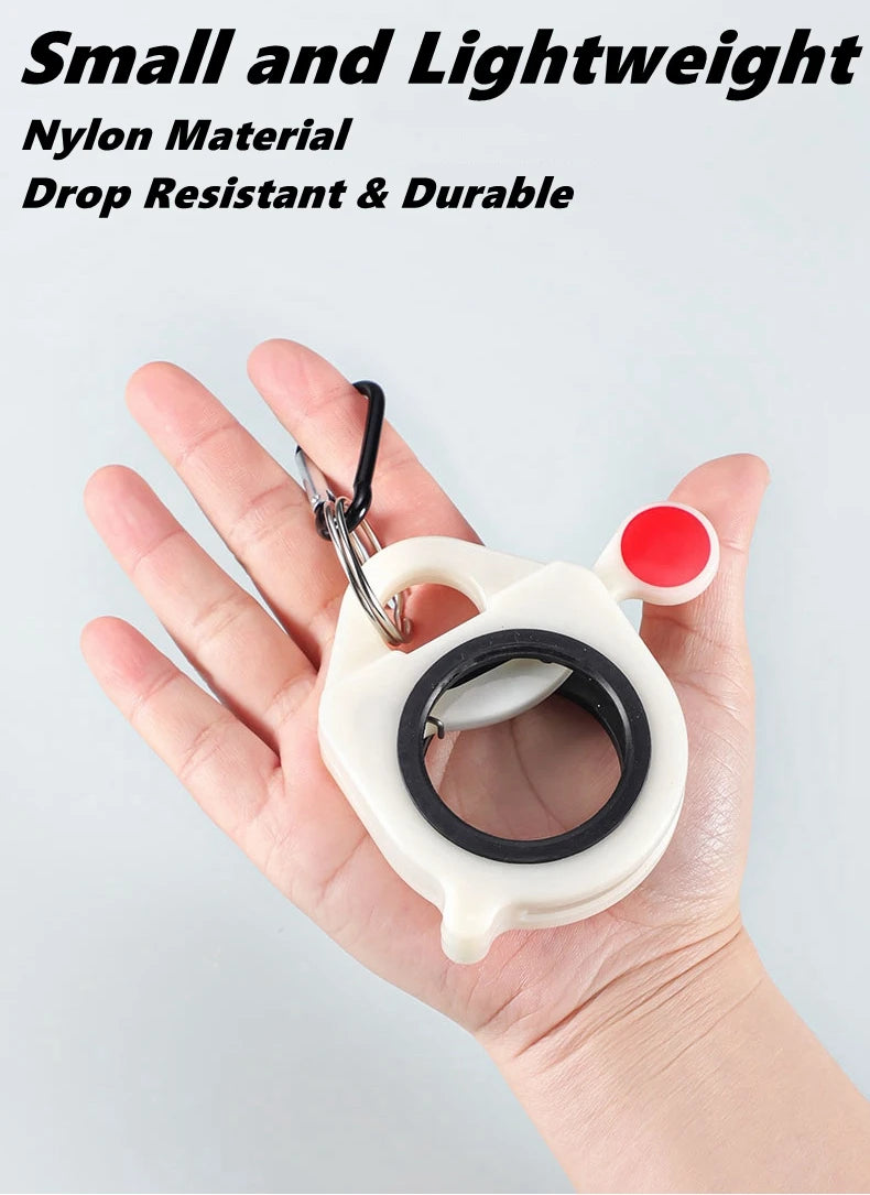 A hand holds a white fluorescent cable tie with a black ring and red cap, demonstrating its size and durability.