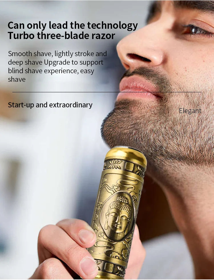 A close-up of a gold-colored electric razor with a Buddha design is being held by a man's hand.