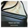 Black leather crossbody bag showing the neat car line detail on the flap and strap.