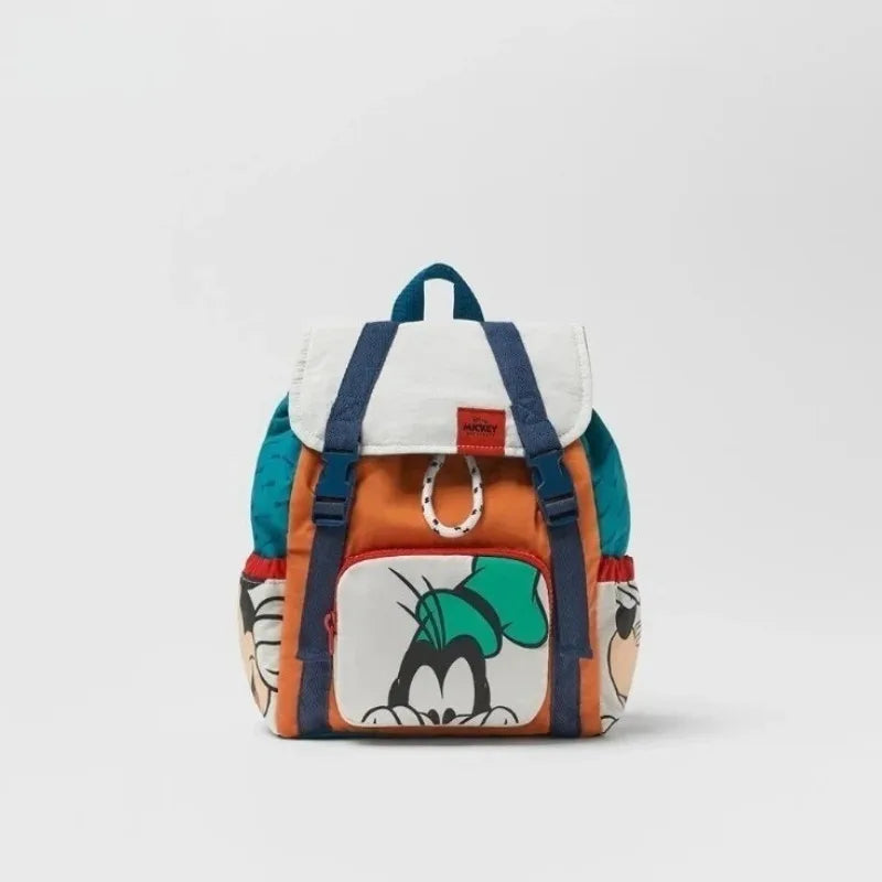An orange and white cow print nylon backpack with blue trim and a black face design.