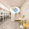 A set of ten colorful foldable travel clothes hangers with anti-slip grips displayed in a bright, modern laundry room.