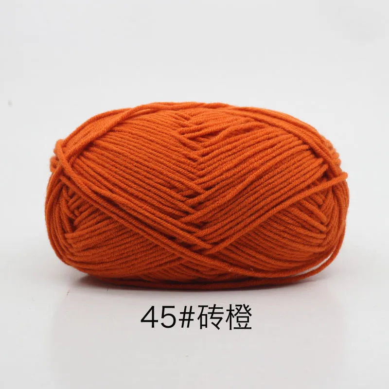 A ball of orange 4-ply milk cotton yarn for knitting and crochet.