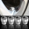 A set of four silver tire valve caps featuring an American flag design, shown in close-up against a dark background.
