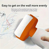 An orange and white paint roller brush is shown applying paint evenly to a white surface.