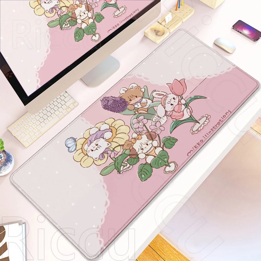 A pink kawaii cartoon gaming desk mat featuring cute woodland animals and flowers with a non-slip rubber base.