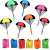 A collection of colorful hand-thrown parachute toys in various shapes and colors like green, blue, pink, yellow, orange, and 