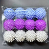 A clear plastic package containing various reusable laundry balls in shades of blue, purple, and white.