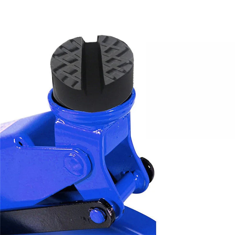 A close-up view of a blue car jack with a black rubber pad and slotted frame rail adapter.