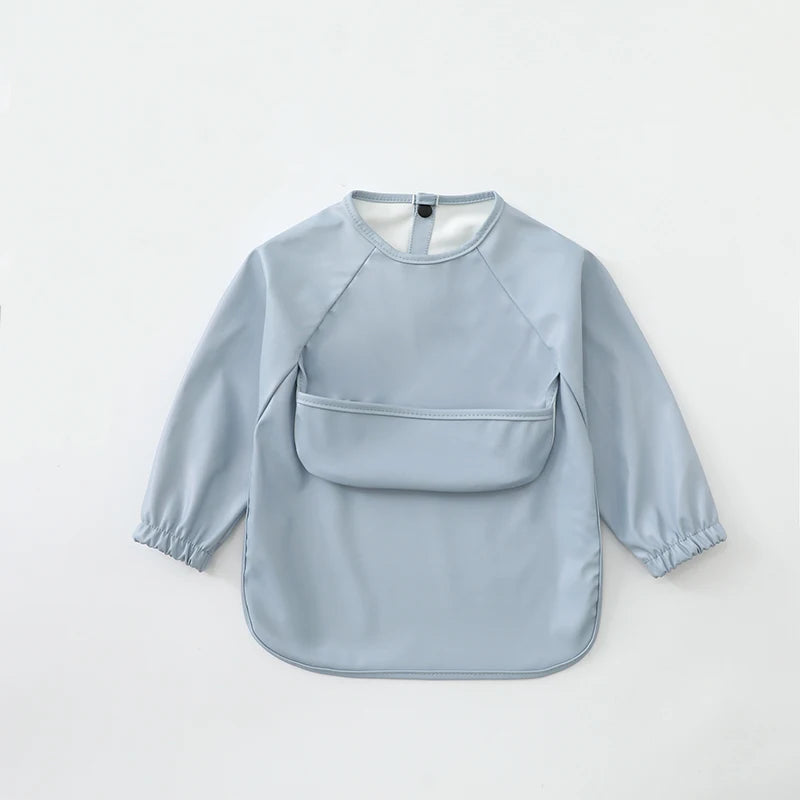 Light blue waterproof long-sleeve smock for toddlers with a collar and patch pockets