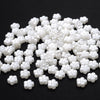 A pile of 100 white acrylic pearl spacer beads for jewelry making
