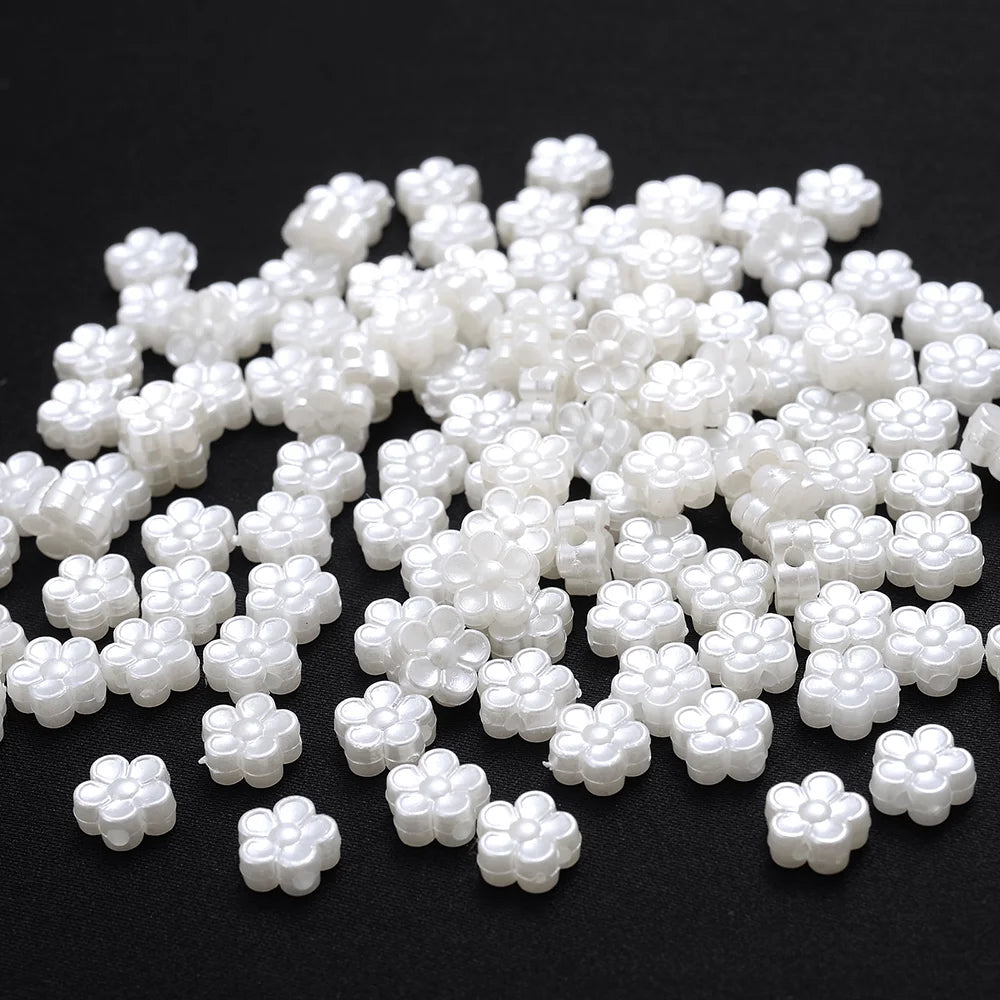A pile of 100 white acrylic pearl spacer beads for jewelry making