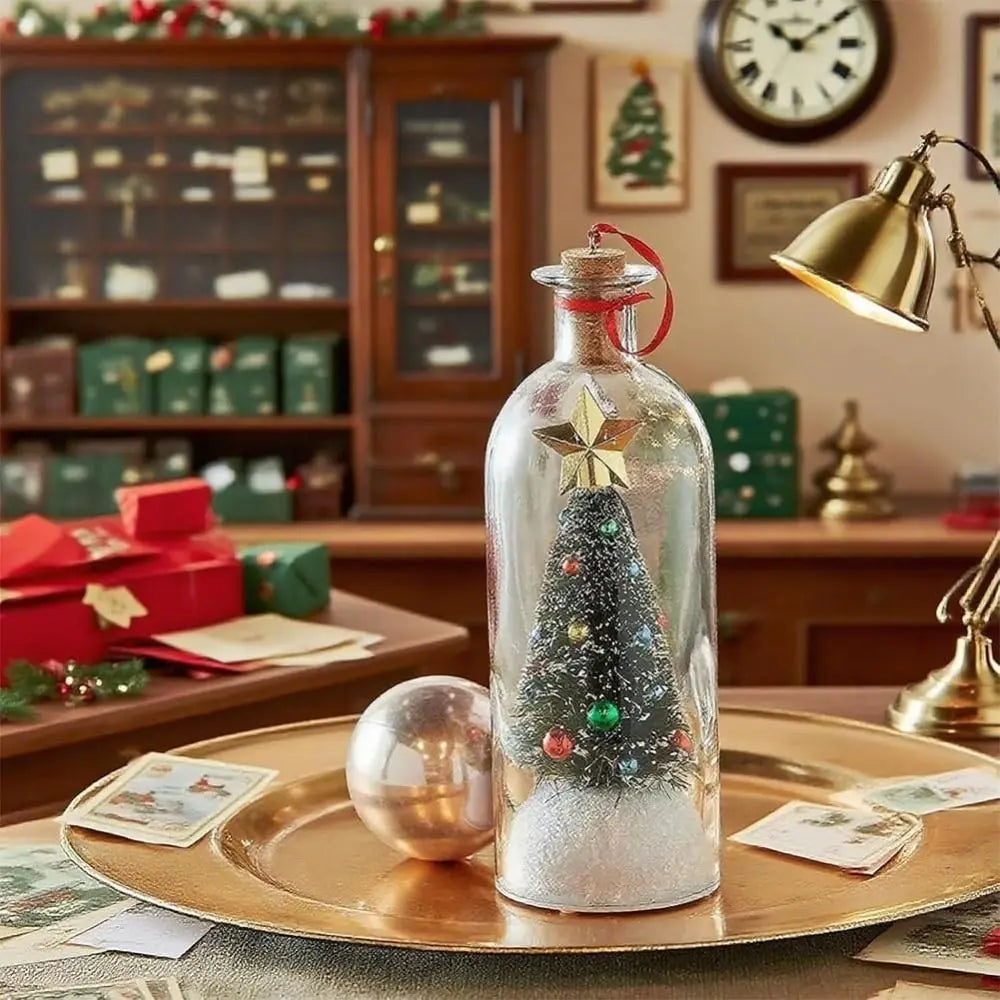 A glass bottle shaped like a Christmas tree with glitter and ornaments sits on a gold plate in a festive holiday setting.