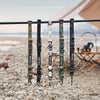 A close-up of a black strap with various colored hanging rings displayed on a horizontal bar.
