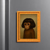 A framed painting of a brown monkey portrait with an orange and gold decorative frame.