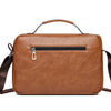 A brown faux leather crossbody bag with a zipper and leather strap is shown against a white background.