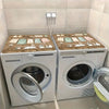 A white laundry room washer and dryer set with wooden top covers and non-slip protection.
