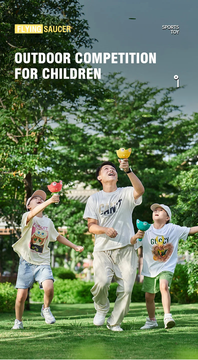 Three children playing outdoors with flying saucer toys in a grassy park setting.