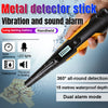 A hand holds a black metal detector stick with an orange grip, demonstrating its vibration and sound alarm features.