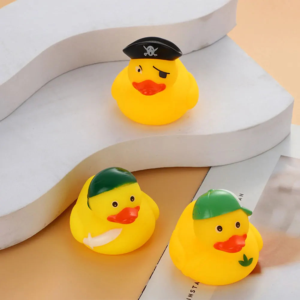 A yellow rubber duck toy with a black hat and orange beak is displayed on a white surface.
