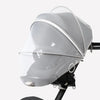 A clear, dome-shaped mosquito net cover for a baby stroller or crib.