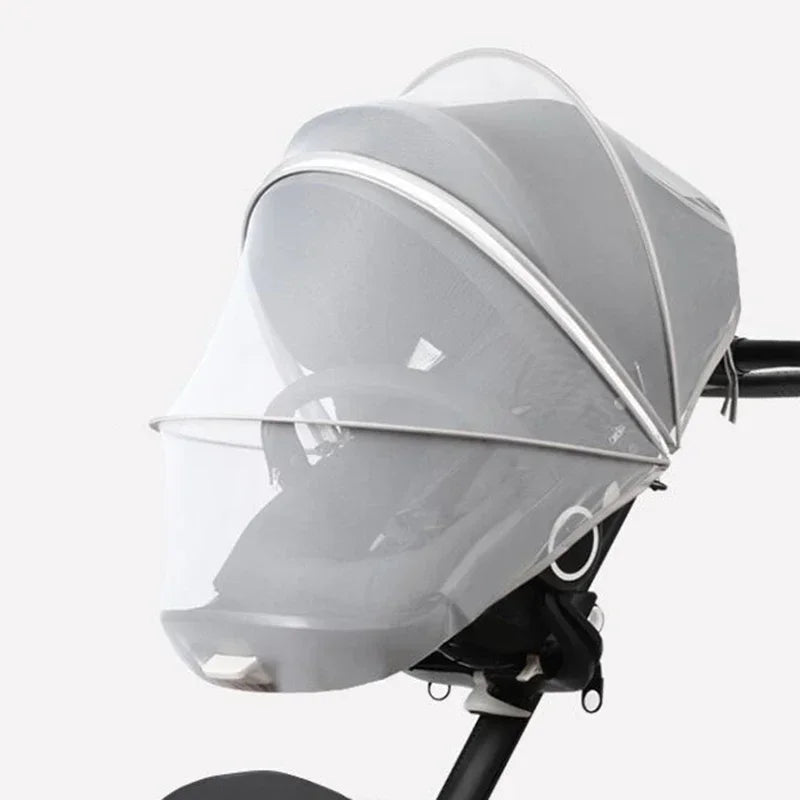 A clear, dome-shaped mosquito net cover for a baby stroller or crib.