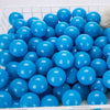A large quantity of bright blue plastic ball pit balls are visible in a white basket.