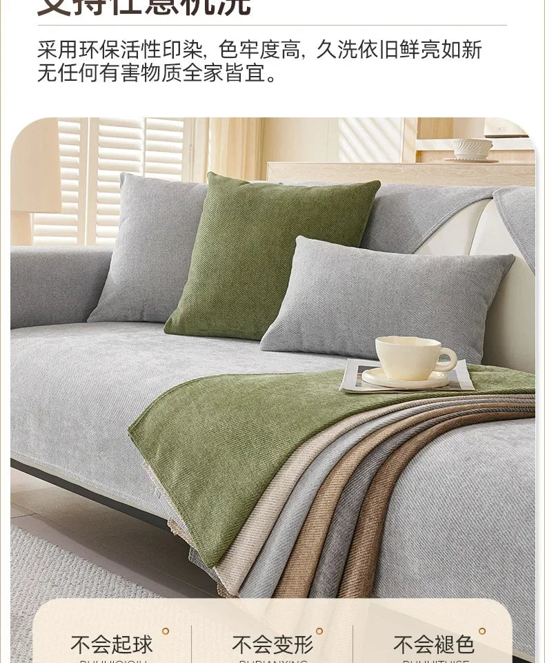 A solid olive green chenille non-slip sofa cover is draped over a gray sofa, showing various fabric textures.