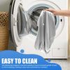 A hand is placing a gray zippered pillowcase into the drum of a white washing machine for cleaning.