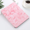 A pink marble patterned case for an iPad Pro with a built-in pencil holder resting on a white surface.