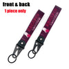 A single dark purple keychain featuring an anime girl design with a steel clip.