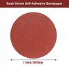 A circular piece of reddish-brown velvet self-adhesive sandpaper measuring 7 inches (180mm).