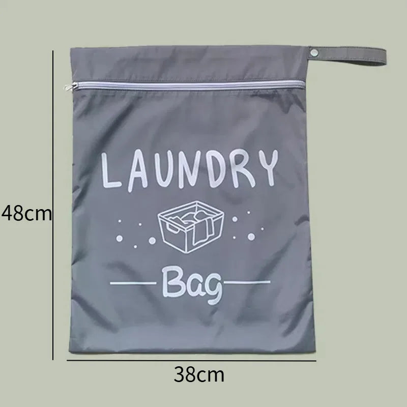 A gray portable waterproof laundry bag with a zipper and a label reading LAUNDRY Bag